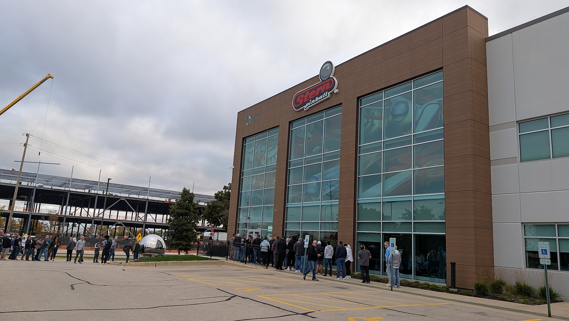 An early morning line begins to form outside of Stern HQ as busses of Pinball Expo attendees arrived for tours.